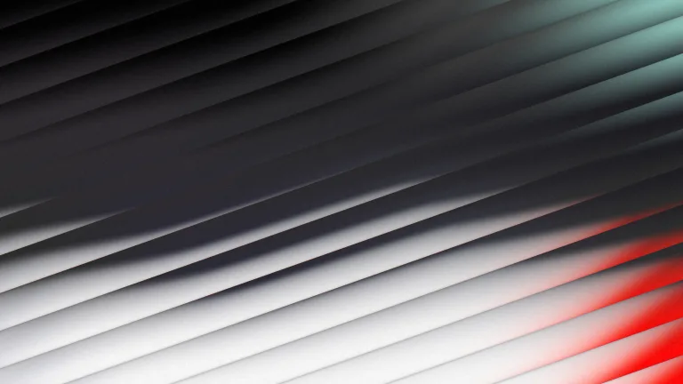 Charcoal and silver through diagonal glass, with mint and red fringes.