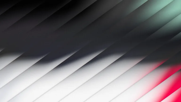 Charcoal and silver through diagonal glass, with mint and red fringes.
