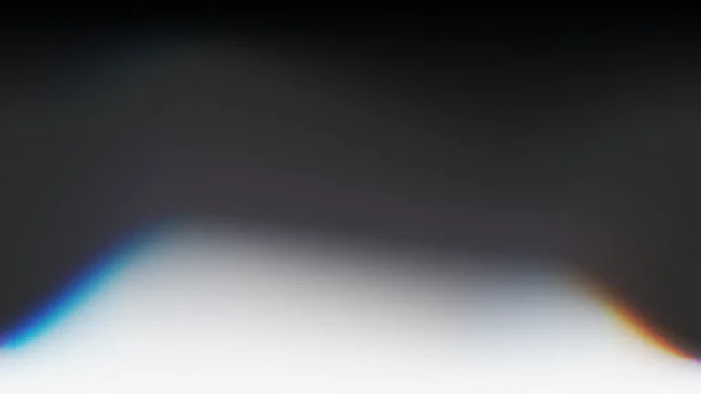 A deep graphite field opening into a soft white horizon.