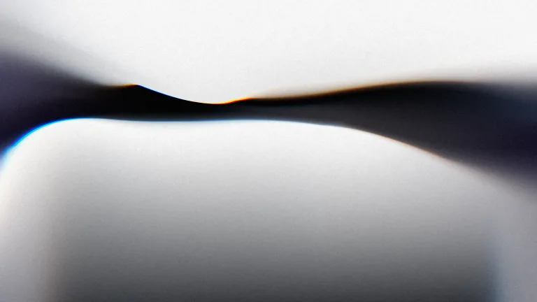 Silver folds around an ink-blue seam, edged with spectral light.